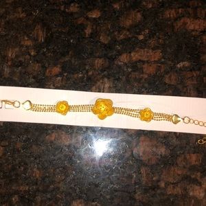 gold-toned, multi-strand bead chain bracelet ,flower heart-shaped accents.